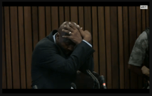 Mangena showing position of arms during head wound