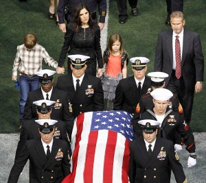 Taya Kyle and her children walk behind the coffin of her slain husband former Navy SEAL Chris Kyle during a memorial service for the former sniper at Cowboys Stadium in Arlington