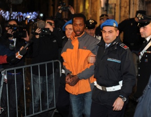 Rudy Guede (C) is escorted from the courthouse at the end of his appeal against the sentence he received in the Meredith Kercher murder trial, in Perugia December 22, 2009. Guede, the Ivorian youth accused of complicity, along with Amanda Knox and Raffaele Sollecito, in the November 2007 murder of British student Kercher was sentenced to 30 years in jail in October 2008 but his appeal has seen his sentence reduced to 16 years. REUTERS/Alessandro Bianchi (ITALY - Tags: CRIME LAW) - RTR28AHA