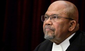 Judge Lex Mpati, president of the Supreme Court of Appeal, attends a hearing during an appeal against South African paralympian Oscar Pistorius' conviction last year at the Supreme Court of Appeal (SCA) in Bloemfontein on November 3, 2015. South African state prosecutors argued in court for Oscar Pistorius to be convicted of murder and sent back to jail, two weeks after he was released on house arrest. The disgraced Paralympic sprinter was found guilty last year of culpable homicide -- a charge equivalent to manslaughter -- after shooting dead his girlfriend Reeva Steenkamp on Valentine's Day in 2013. AFP PHOTO / POOL / SIPHIWE SIBEKO